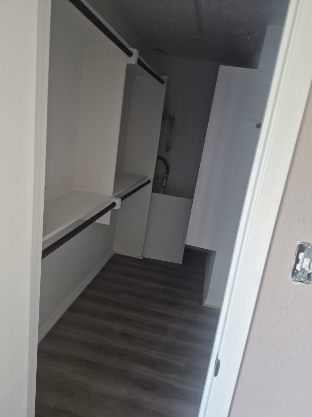Closet with shelving, hanging rods and new flooring